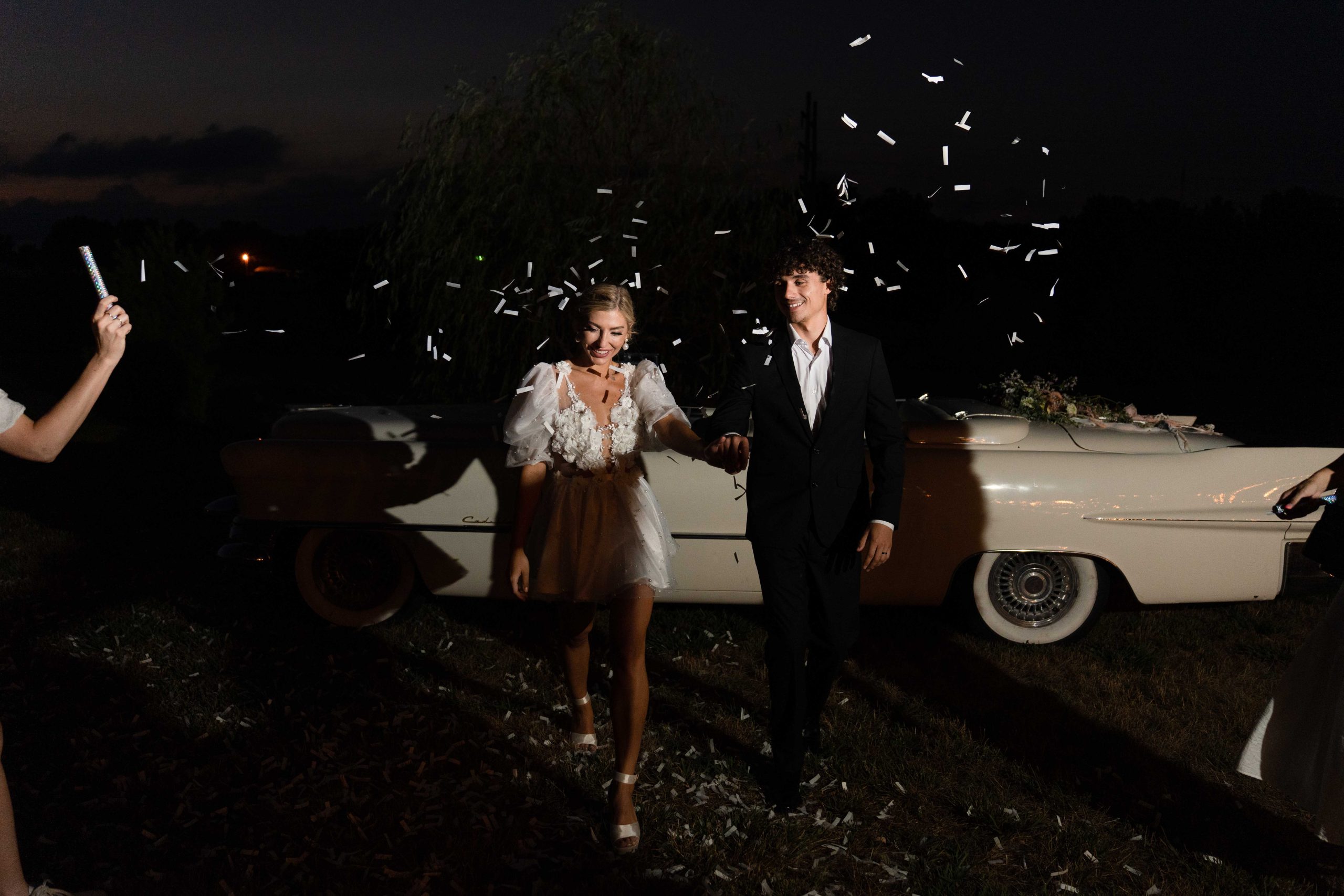 Wedding couple at night with confetti