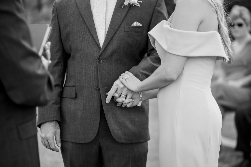 holding hands by lake of the Ozarks wedding photographer The Bennetts