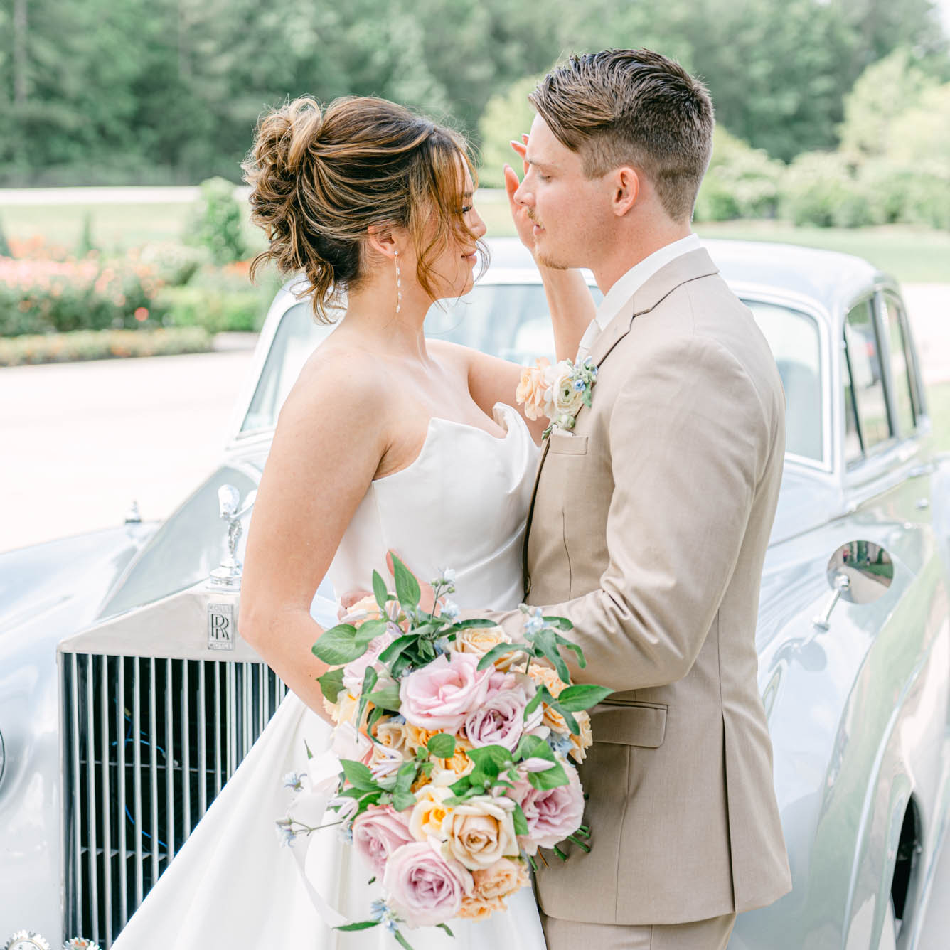 bride and groom with Rolls-Royce by St. Louis wedding photographers The Bennetts