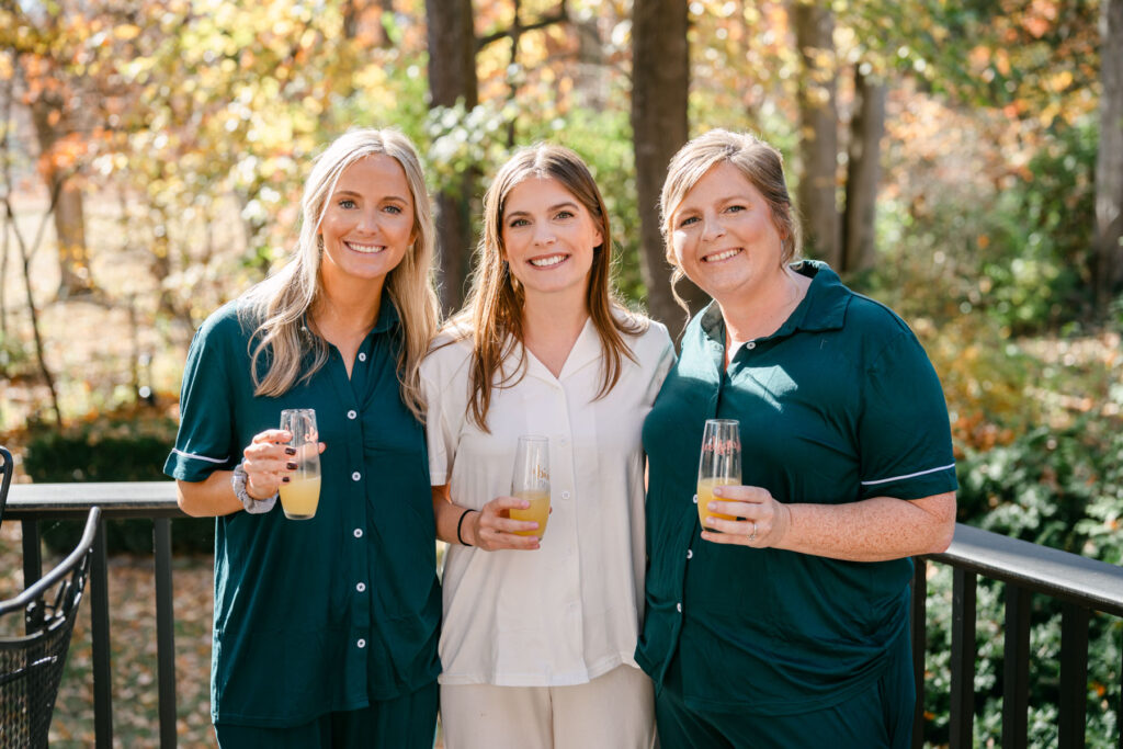 bride and bridesmaids with mimosas outside in the fall