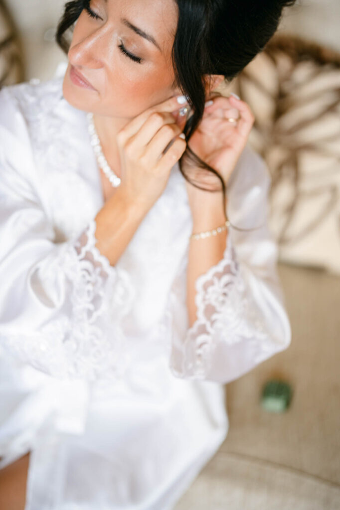 bride putting in earrings